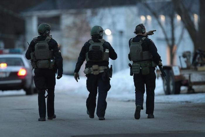 Police secure the area after a gunman opened fire in Aurora, Illinois -- the latest mass shooting to hit the United States