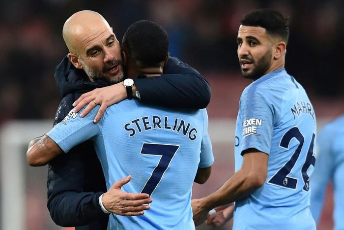 Pep Guardiola celebrates as goal hero Riyad Mahrez looks on