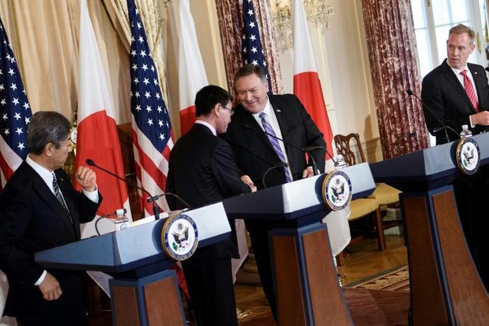 Secretary of State Mike Pompeo shakes hands with Japanese Foreign Minister Taro Kono as the allies' defense chiefs look on