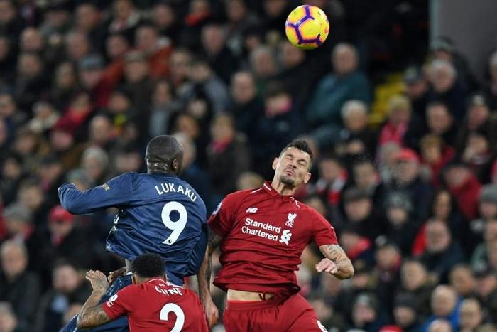 Liverpool's Dejan Lovren (right) in action against Manchester United