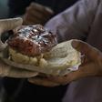 A man receives a "choripan" (grilled sausage on bread) for free during a protest in Buenos Aires