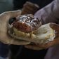 A man receives a "choripan" (grilled sausage on bread) for free during a protest in Buenos Aires