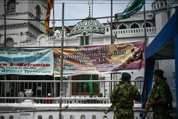 Soldiers stand guard outside a mosque ahead of Friday noon prayers in Colombo as many Muslims fear retaliation for the Easter attacks