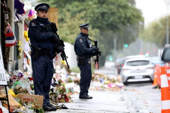 Armed police officers stand guard outside one of the mosques where some 50 people were killed by a self-avowed white supremacist gunman on March 15 in Christchurch