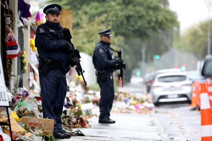 Armed police officers stand guard outside one of the mosques where some 50 people were killed by a self-avowed white supremacist gunman on March 15 in Christchurch