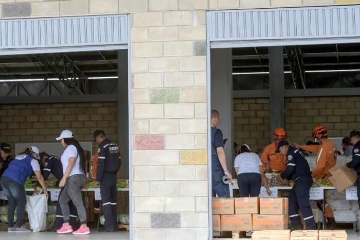 Volunteers and officials organize US aid shipments in Cucuta, Colombia -- but the Venezuelan military is blocking it from crossing the border