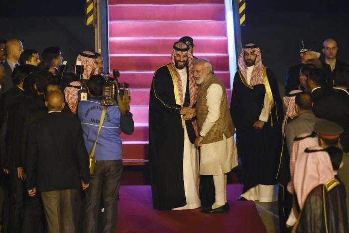 Saudi Crown Prince Mohammed bin Salman is greeted by Indian Prime Minister Narendra Modi upon arriving in New Delhi