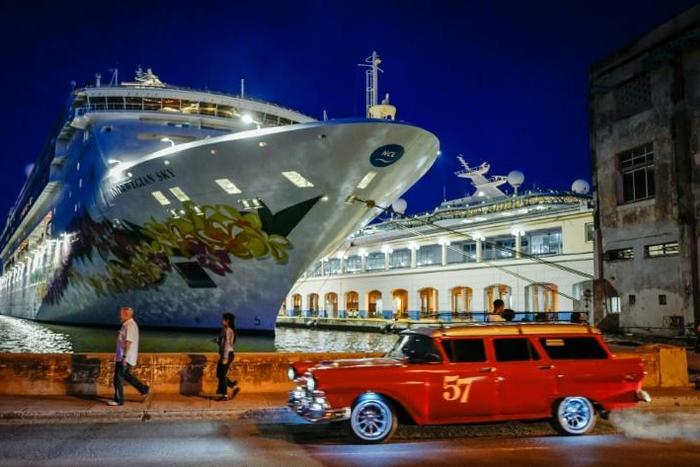An old American car passes by the "Empress of the Seas", the last US-operated cruise ship to dock in Cuba following fresh US sanctions that ban stopovers on the island