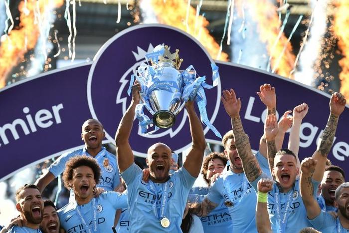 Manchester City captain Vincent Kompany holds up the Premier League trophy after their 4-1 victory against Brighton
