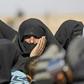 Civilians fleeing fighting between Syrian Democratic Forces (SDF) and Islamic State (IS) jihadists in the frontline Syrian village of Baghuz, wait to be screened in the countryside of the eastern Syrian on February 3, 2019