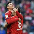 James Rodriguez and Javi Martinez celebrate the goal that took them level on points with Borussia Dortmund