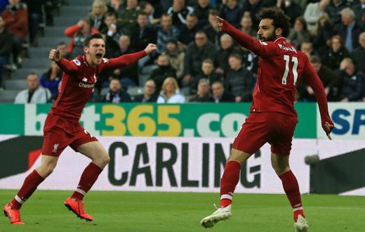 Liverpool's Egyptian midfielder Mohamed Salah (R) celebrates with Liverpool's Scottish defender Andrew Robertson (L) after scoring their second goal during the English Premier League football match between Newcastle United and Liverpool at St James' Pa...