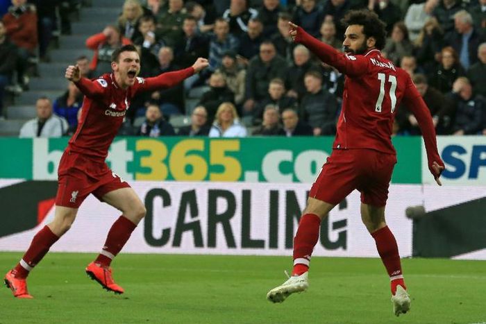 Liverpool's Egyptian midfielder Mohamed Salah (R) celebrates with Liverpool's Scottish defender Andrew Robertson (L) after scoring their second goal during the English Premier League football match between Newcastle United and Liverpool at St James' Pa...