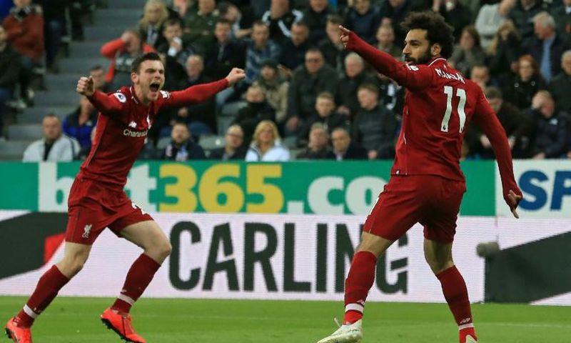 Liverpool's Egyptian midfielder Mohamed Salah (R) celebrates with Liverpool's Scottish defender Andrew Robertson (L) after scoring their second goal during the English Premier League football match between Newcastle United and Liverpool at St James' Pa...