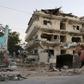 A heavy equipment loader cleans debris outside the Maka Al-Mukarama hotel in the Somali capital Mogadishu, one day after a deadly suicide car bombing