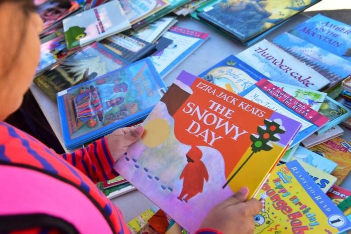 A student at Telfair Elementary School in Los Angeles county makes her choice for a free book during a morning at Operation School Bell -- a quarter of the school's 720 children are in need of food, shelter or clothing