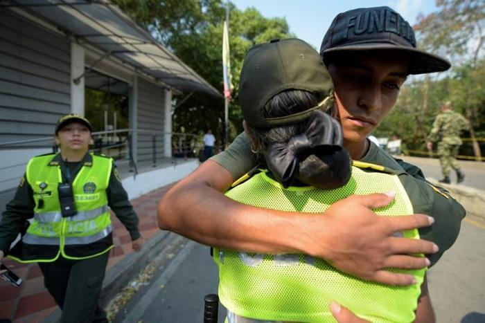 A Colombian police officer hugs a deserting Venezuelan soldier who crossed the border on February 25, 2019