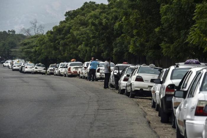 Drivers lining up to buy gasoline in crisis-hit Venezuela, close to the border with Colombia, where the US military is shipping another 200 tons of military aid