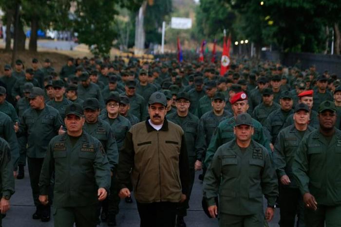 The Colombian foreign ministry said the military personnel were "identified by locals as belonging to the Bolivarian Armed Forces, at the service fo the (Nicolas) Maduro regime" (C, pictured May 2, 2019 with military troops)