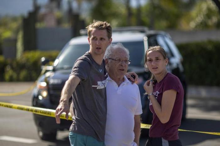 People embrace on April 27, 2019 outside the synagogue in Poway, California, where a gunman opened fire earlier, killing a woman and wounding three people