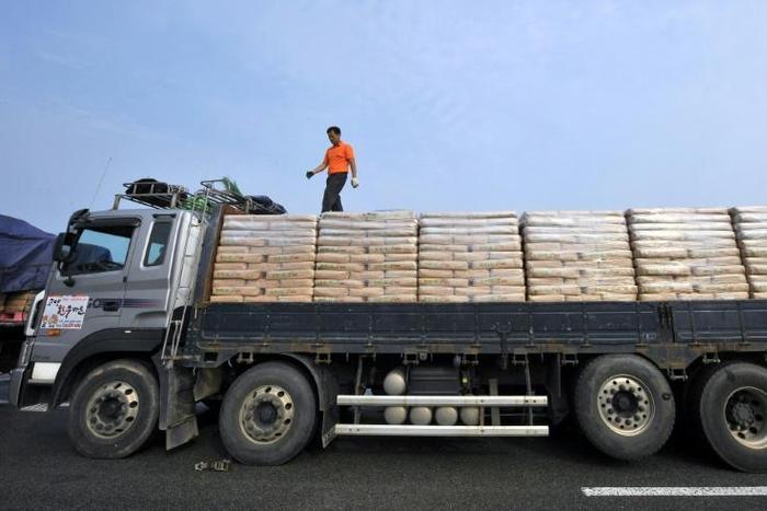 A South Korean driver checks sacks of flour bound for North Korea before crossing the inter-Korean border in Paju, north of Seoul