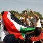 Sudanese protesters wave the national flag during an anti-government demonstration in the capital Khartoum's twin city of Omdurman on January 31, 2019