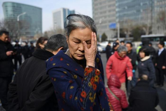 Relatives of the passengers on missing Malaysia Airlines flight MH370 gathered outside the foreign ministry on Friday to demand answers