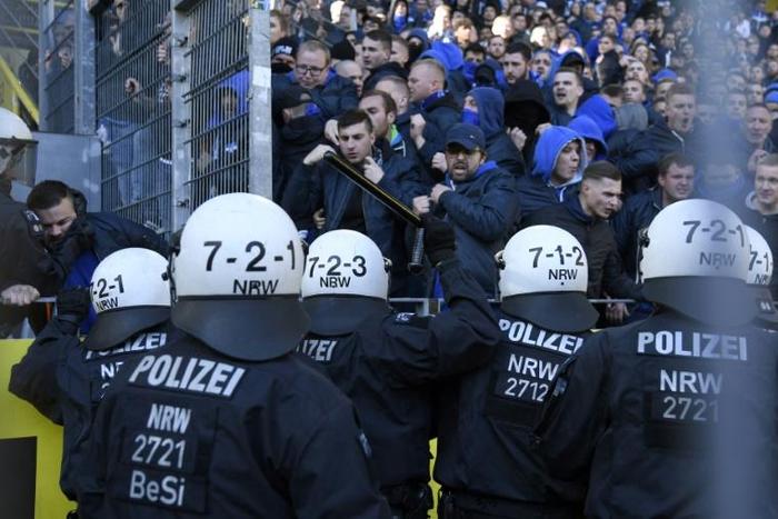 Schalke's supporters face police officers during a heated local derby against Borussia Dortmund on Saturday