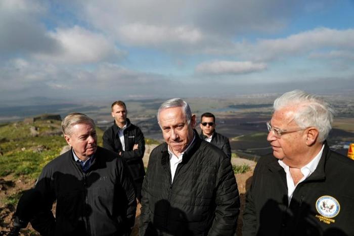 (L to R) US Senator Lindsey Graham is accompanied by Israeli Prime minister Benjamin Netanyahu and US Ambassador to Israel David Friedman as they visit the border line between Syria and the Israeli-annexed Golan Heights