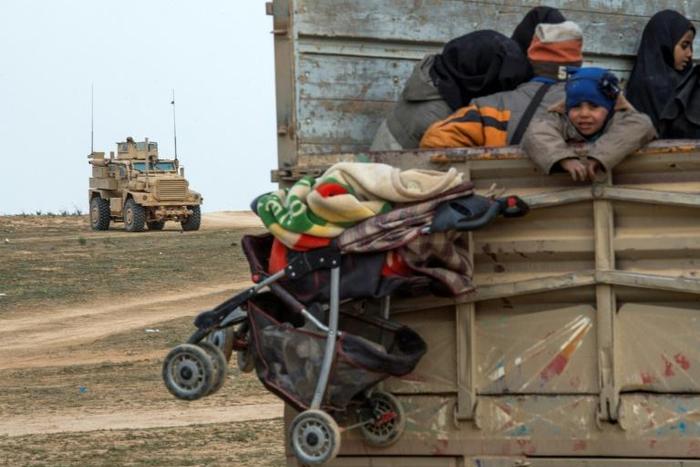 Kurdish-led forces say that concern for the truckloads of civilians who are pouring out of the Islamic State group's last redoubt is slowing their advance on the final square kilometre still held by jihadist diehards in Syria