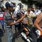 Protesters in the Venezuelan border town of Urena carry off a person wounded in a demo demanding to cross into Colombia seeking aid