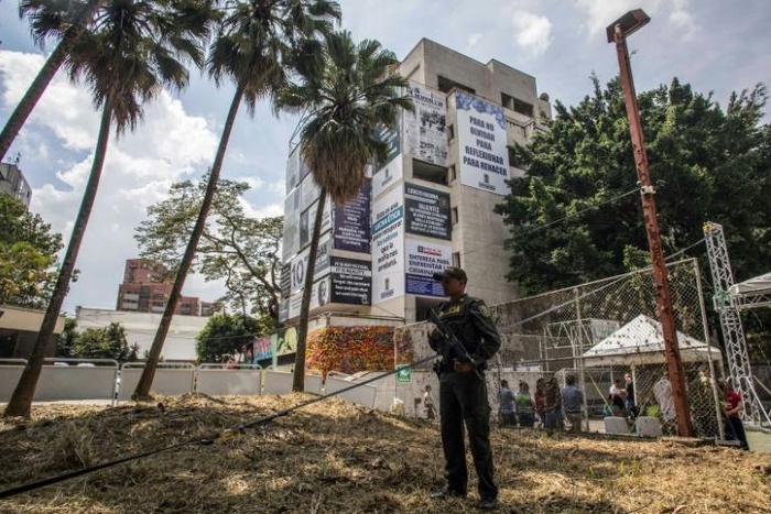 A police officer stands guard outside the Monaco building that was once the Medellin home of late drug baron Pablo Escobar