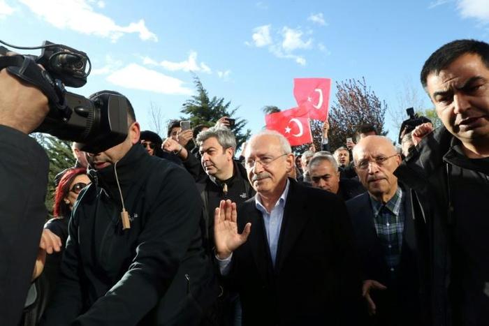 The chairman of the Republican People's Party (CHP) Kemal Kilicdaroglu (C) was assaulted by a mob at a soldier's funeral on Sunday