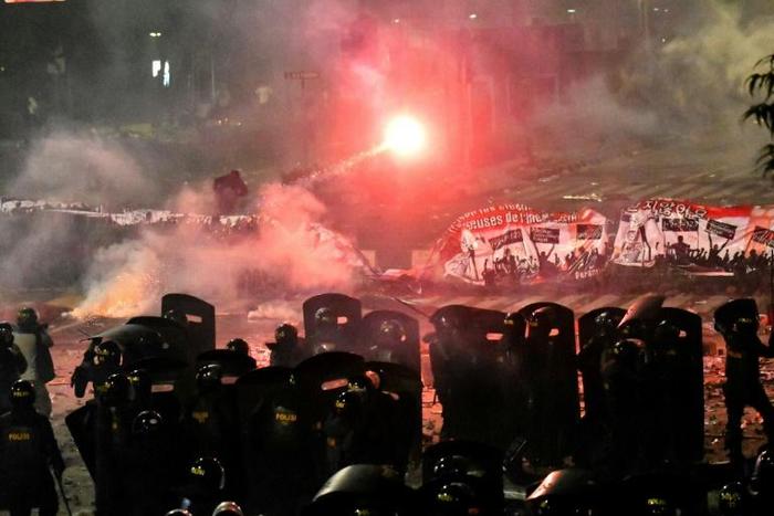 Indonesian riot police fire tear gas at protesters demonstrating against the re-election of Indonesian president Joko Widodo. Authorities say they uncovered an assassination plot that could have been libnked to the riots