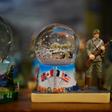 Snow globes commemorating the June 1944 Normandy landings at a souvenir shop in Saint-Côme-du-Mont, France
