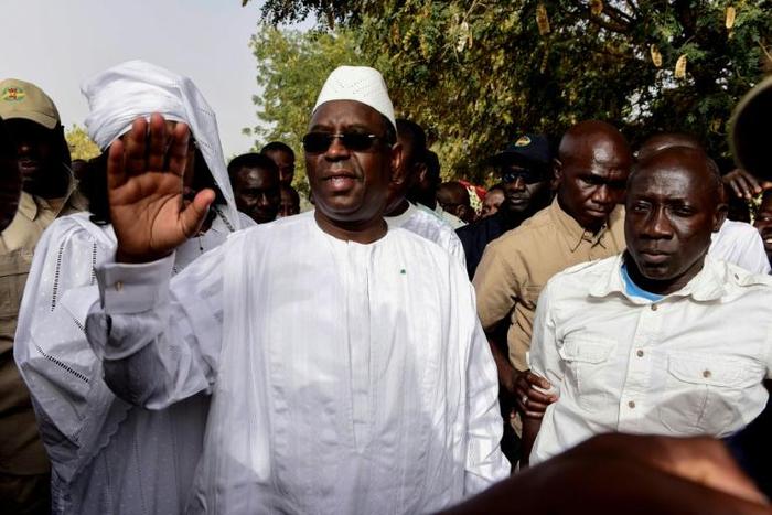 Incumbent President Macky Sall (C) is expected to win enough votes to claim a first-round victory, according to local media reports of regional vote tallies