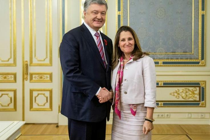 Canadian Foreign Minister Chrystia Freeland (R) shakes hands with shows Ukrainian President Petro Poroshenko during her visit to Kiev, where she affirmed her country "fully supports Ukraine's sovereignty"