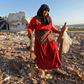A woman salvages items from a building reportedly destroyed by an air strike on the Syrian town of Kafranbel in Idlib province on May 20, 2019