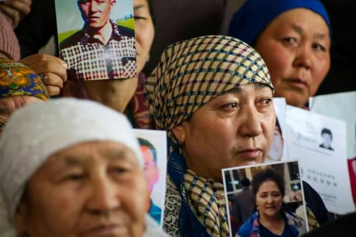 Petitioners with relatives missing or detained in Xinjiang hold up photos of their loved ones during a press event at the office of the Ata Jurt rights group in Almaty, Kazakhstan, on January 21, 2019.
