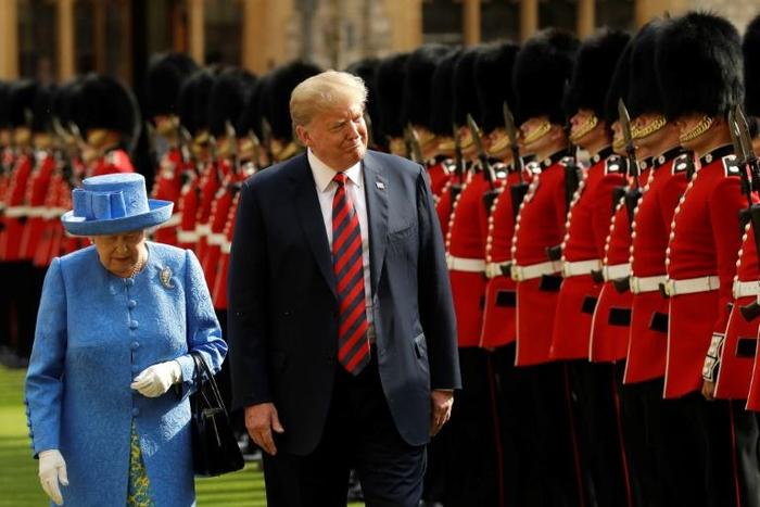 Britain's Queen Elizabeth II (L) and US President Donald Trump (R) inspect the honour guard during his visit to Windsor Castle in July 2018