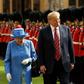 Britain's Queen Elizabeth II (L) and US President Donald Trump (R) inspect the honour guard during his visit to Windsor Castle in July 2018