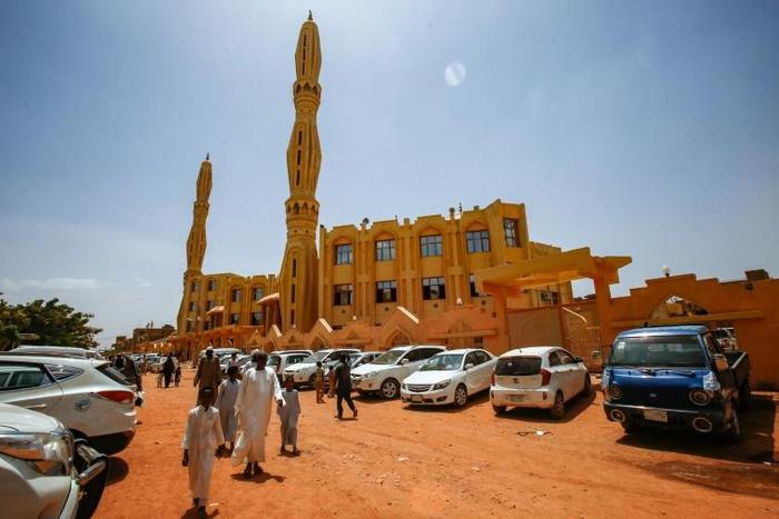 Sudanese worshippers arrive outside a mosque to attend the weekly Friday sermon and prayers during the holy month of Ramadan in the capital Khartoum
