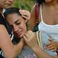 A woman is comforted after two buildings collapsed in the Muzema favela of Rio de Janeiro, Brazil, on April 12, 2019