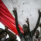 Sudanese protesters shout slogans and flash victory signs during a rally outside the army complex in Sudan's capital Khartoum