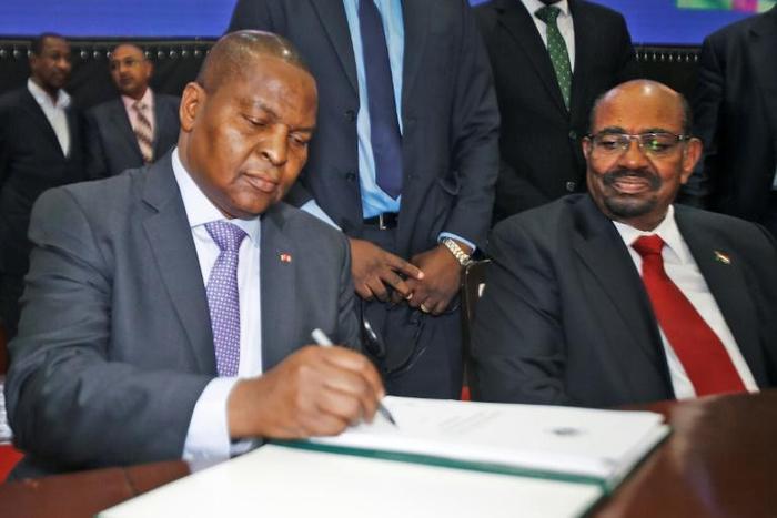 President Faustin Archange Touadera initials the peace agreement his government reached in Khartoum with 14 armed groups