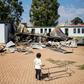 A young member of the 'Coloured' community stands in the courtyard of Oakdale Secondary School in Eldorado Park, on the outskirts of Johannesburg. Several classrooms were destroyed during a student strike in April