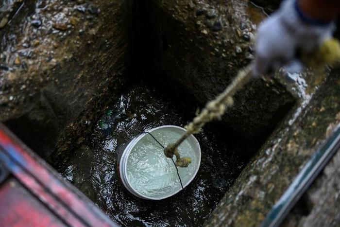 Crippling power blackouts in Venezuela are forcing rich and poor alike to wait in long lines for drinking water, while some hoist it from sewers to be able to flush their toilets