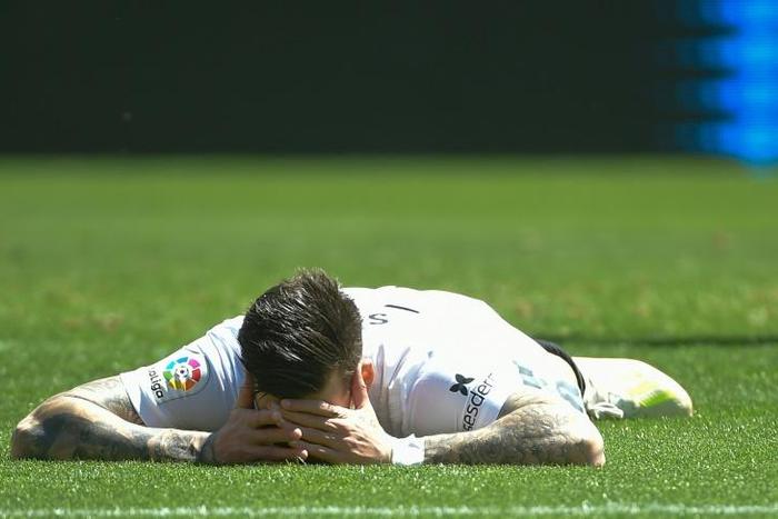 Valencia's Santi Mina lies on the field during their 1-0 defeat to Eibar on Sunday