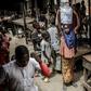 A girl selling water waits for costumers at a market, which was attacked last year by Boko Haram Islamists, in the Nigerian city of Mubi