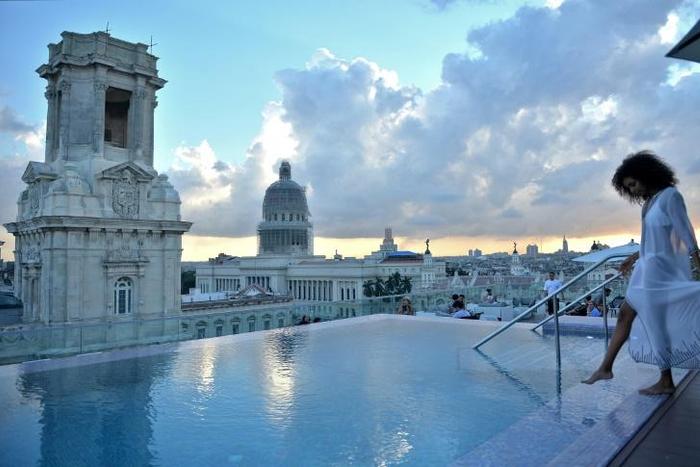 A tourist stands by the rooftop swimming pool at the Gran Hotel Manzana in Havana -- one of many luxury properties attracting tourists in Cuba